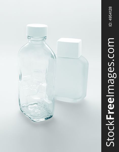 Two empty glass cosmetic containers on the white background. Two empty glass cosmetic containers on the white background