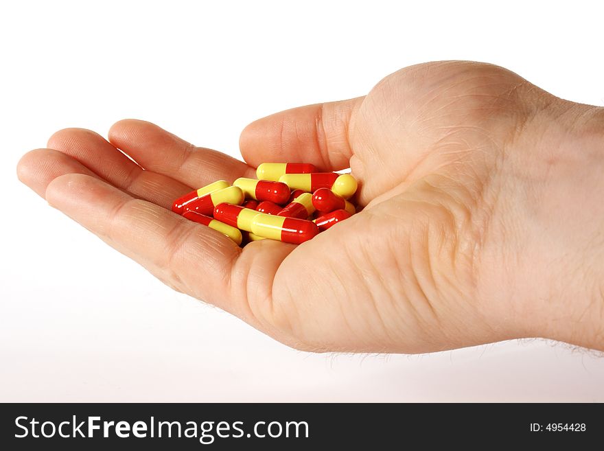 Pills in a hand for healthier living. Pills in a hand for healthier living.