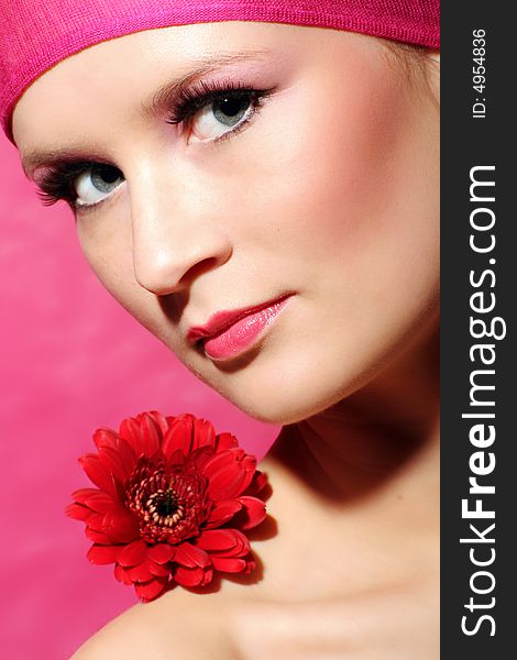 Beauty portrait of a beautiful young woman with a red gerbera flower. Beauty portrait of a beautiful young woman with a red gerbera flower