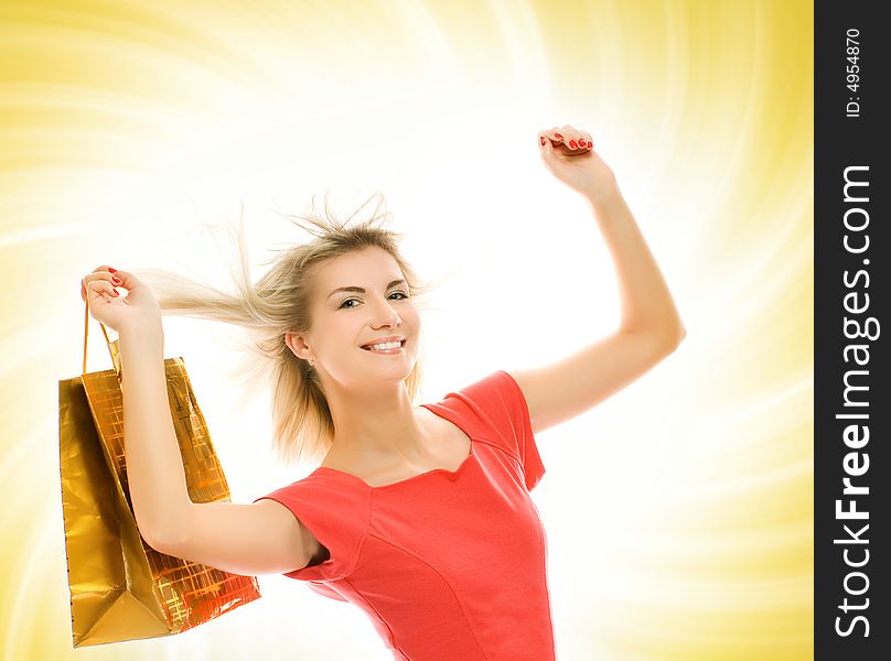 Beautiful young woman with a bag over abstract yellow background