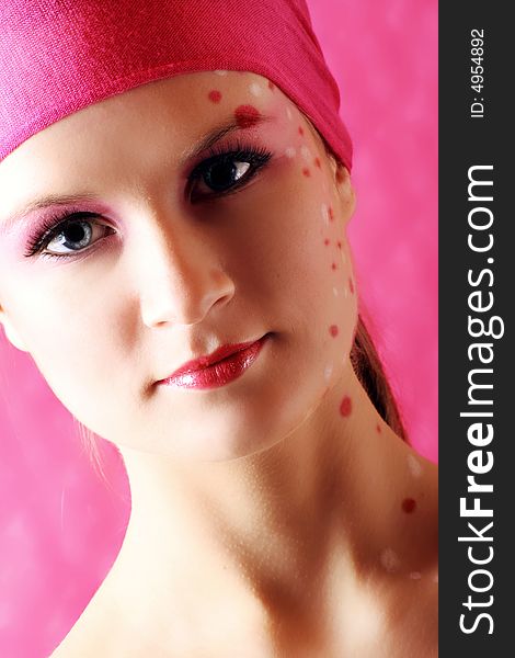 Beauty portrait of a beautiful young woman with pink and white dots on her skin. Beauty portrait of a beautiful young woman with pink and white dots on her skin