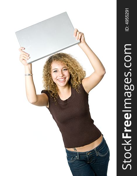 A beautiful young women holding her portable computer above her head. A beautiful young women holding her portable computer above her head
