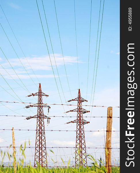 Electricity pylon and power cables over farmland in Italy