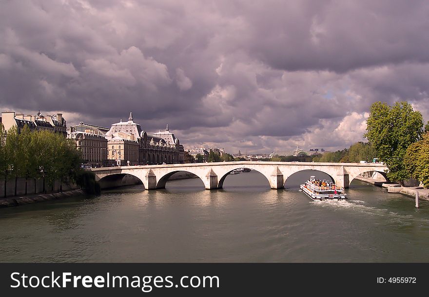 Boat floating under a Paris bridge in (France). Boat floating under a Paris bridge in (France)