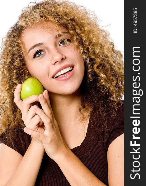 A pretty young woman holding a green apple. A pretty young woman holding a green apple