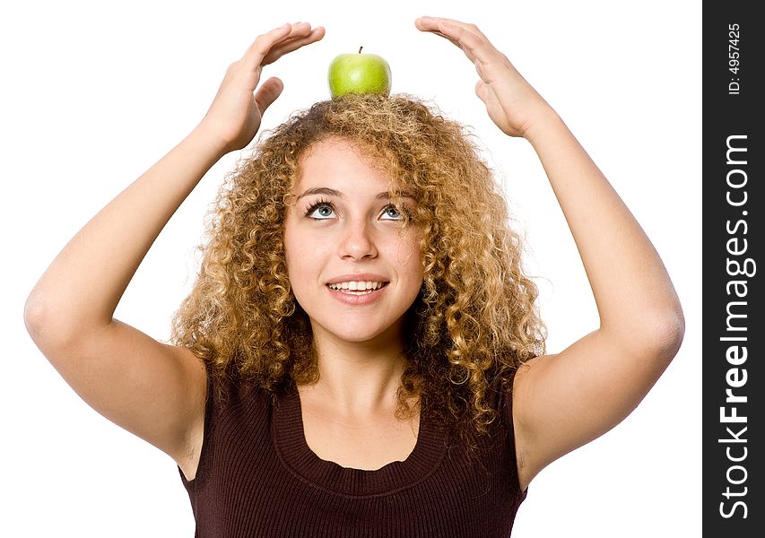 A young woman balancing a green apple on her head. A young woman balancing a green apple on her head