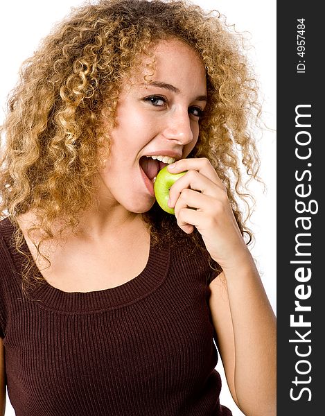 A pretty young woman holding an apple she's about to eat. A pretty young woman holding an apple she's about to eat