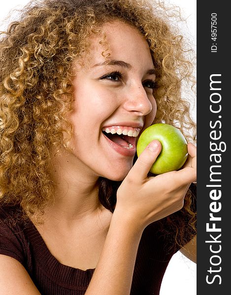 A pretty young woman holding an apple she's about to eat. A pretty young woman holding an apple she's about to eat