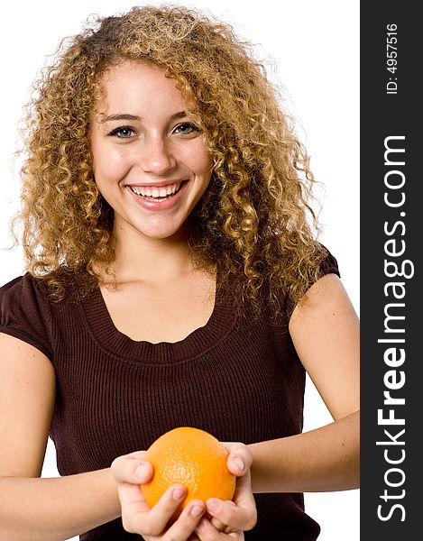 A pretty smiling young woman holding an orange. A pretty smiling young woman holding an orange