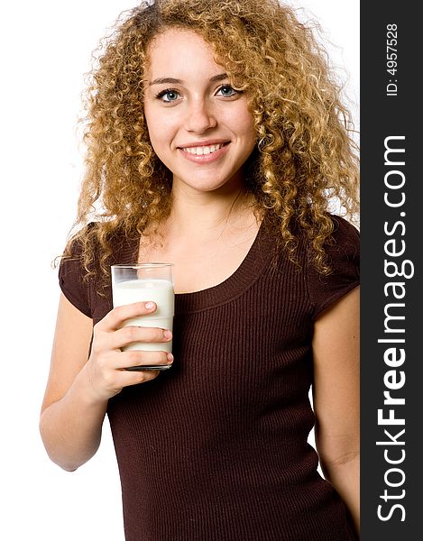 A pretty young woman holding a glass of milk. A pretty young woman holding a glass of milk