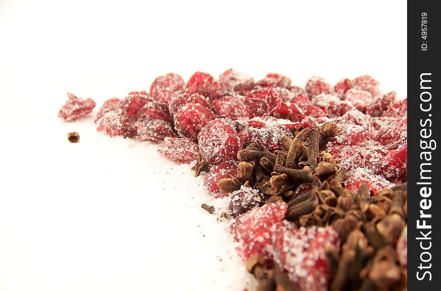 Image of dried cranberries mixed with cloves and white granulated sugar. Image of dried cranberries mixed with cloves and white granulated sugar.