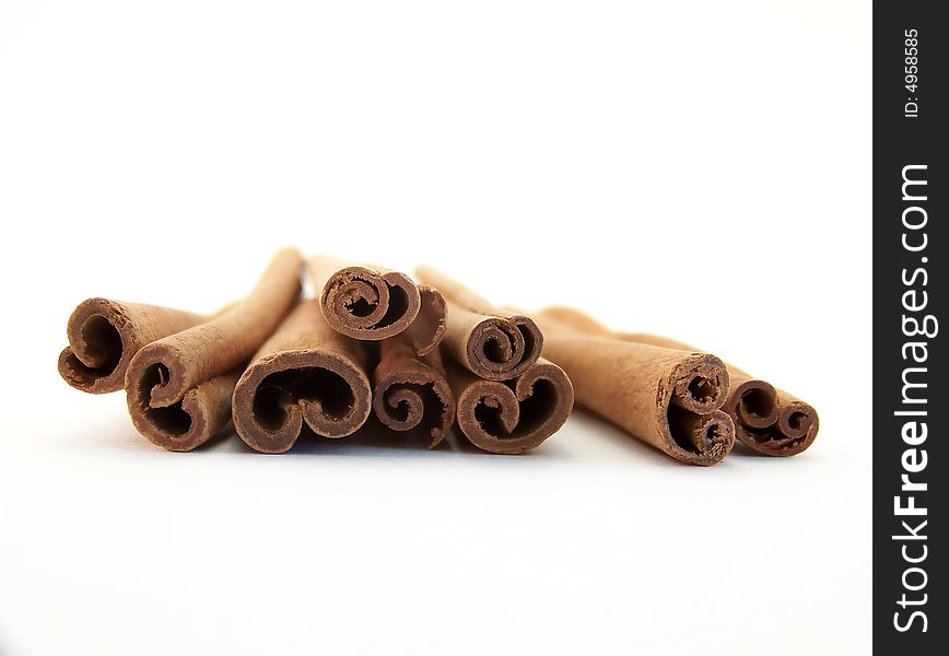 Horizontal image of piled cinnamon sticks, viewed straight on.