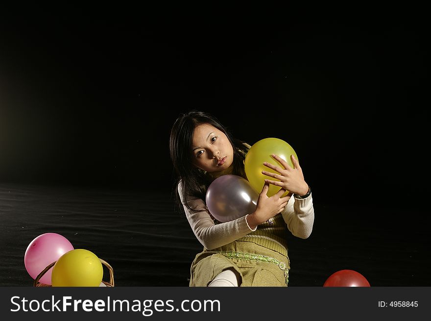 A girl holding the balloons. A girl holding the balloons.