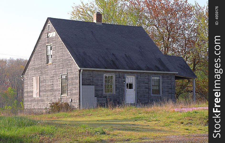 A house in a rural area, found in a state of disrepair. The side porch slumps slightly, some windows are broken and siding missing, but outward appearance is that this could be reinhabited with some repair work. A house in a rural area, found in a state of disrepair. The side porch slumps slightly, some windows are broken and siding missing, but outward appearance is that this could be reinhabited with some repair work.