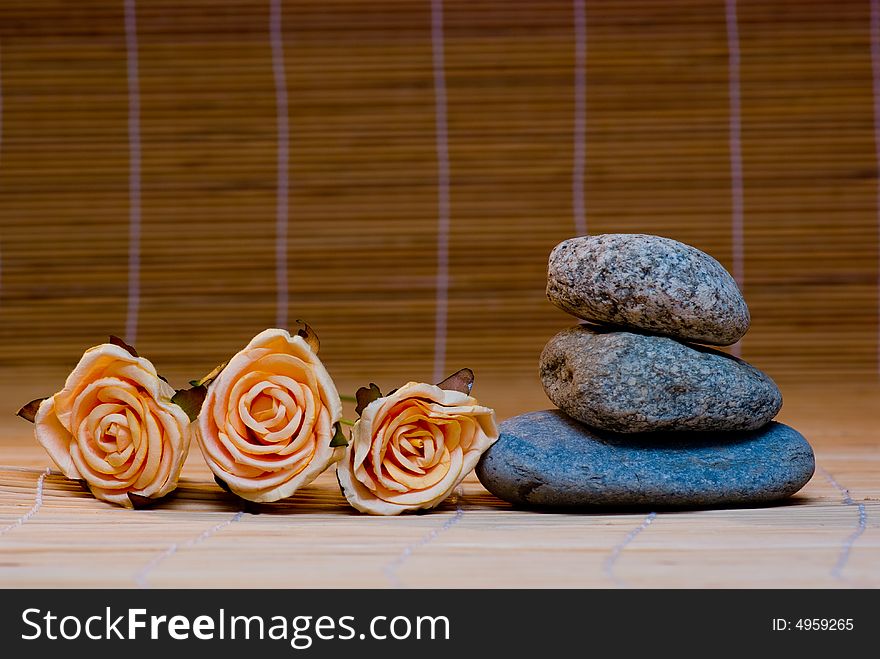 Still life with three round stone and rose