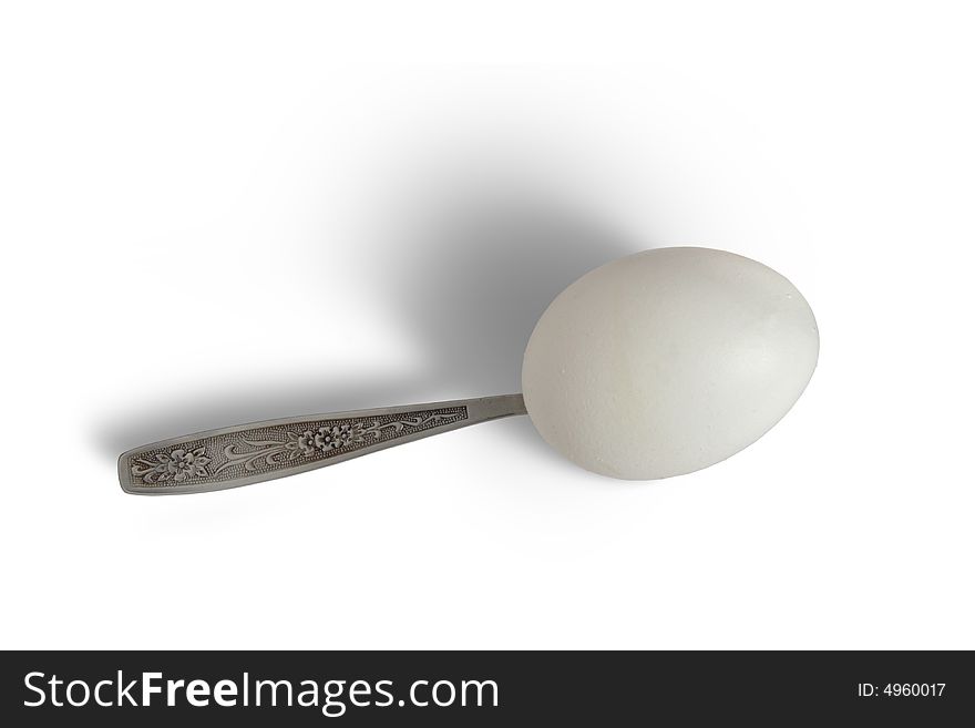 Egg and spoon on a white background