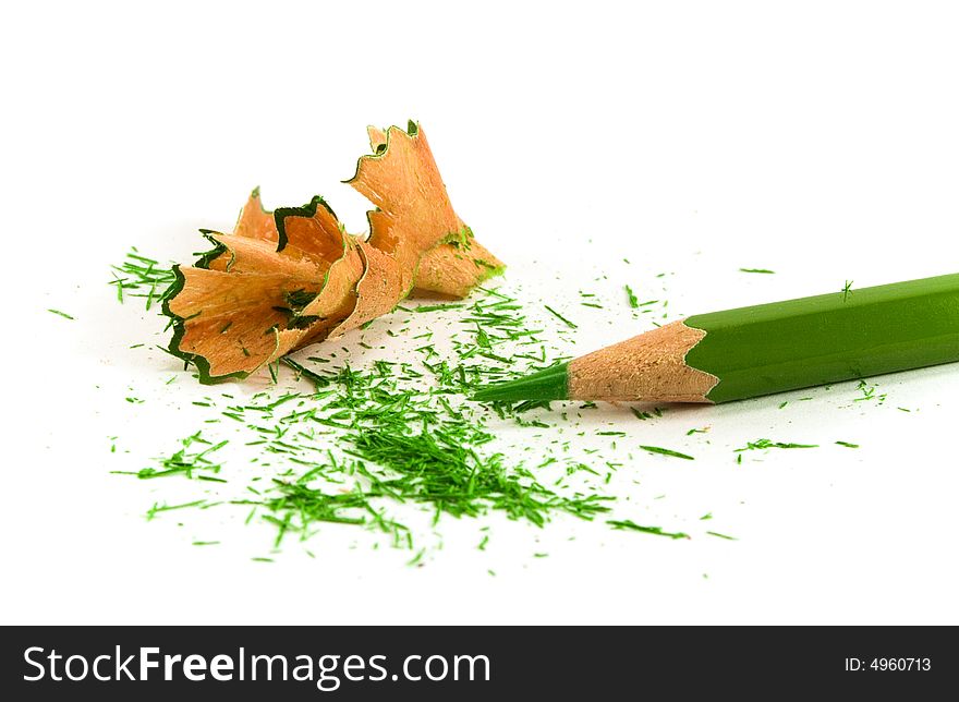 Green pencil and sawdust on white background
