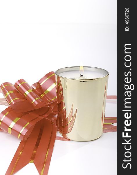 Golden candle with red bow