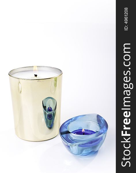 Gold candle and blue candlestick on the white background