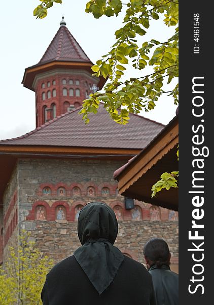 Image of a nun praying in front of a Romanian Monastery. Image of a nun praying in front of a Romanian Monastery.