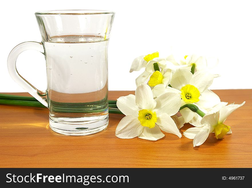 Bouquet of narcissuses and cup of water. Bouquet of narcissuses and cup of water