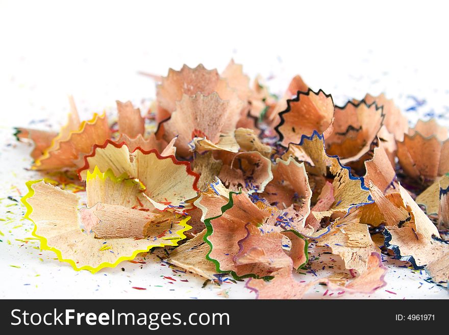 Colourful pencils sawdust over white