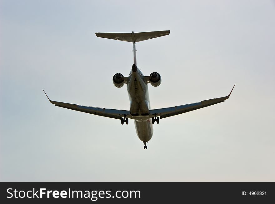 Silhouette of an aeroplane while landing at the urban airport. Silhouette of an aeroplane while landing at the urban airport