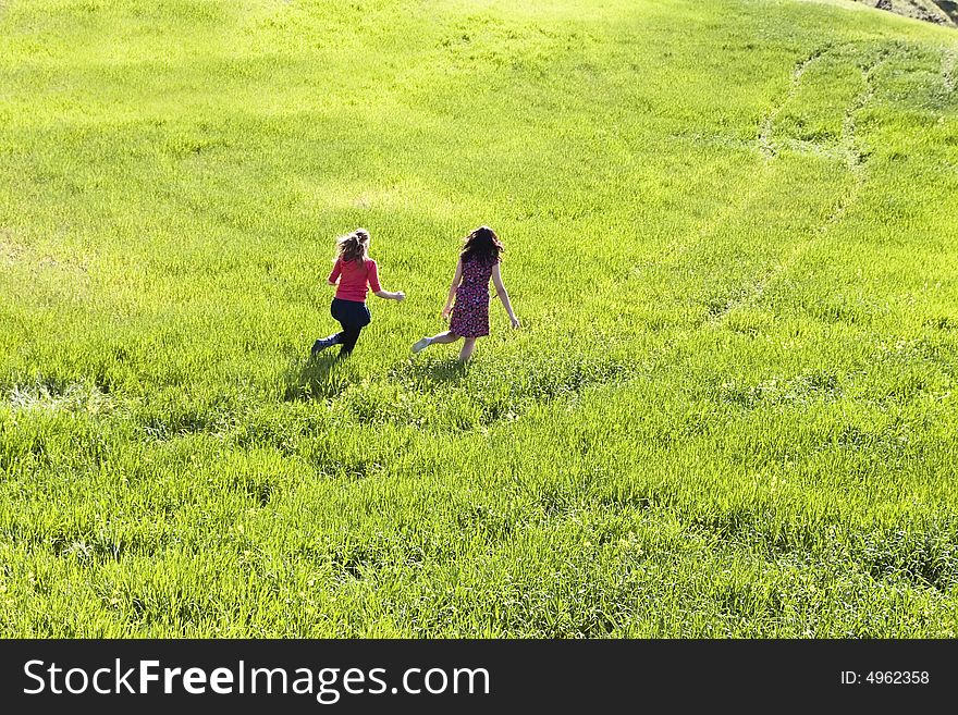 Couple of friends running down the meadow. Couple of friends running down the meadow