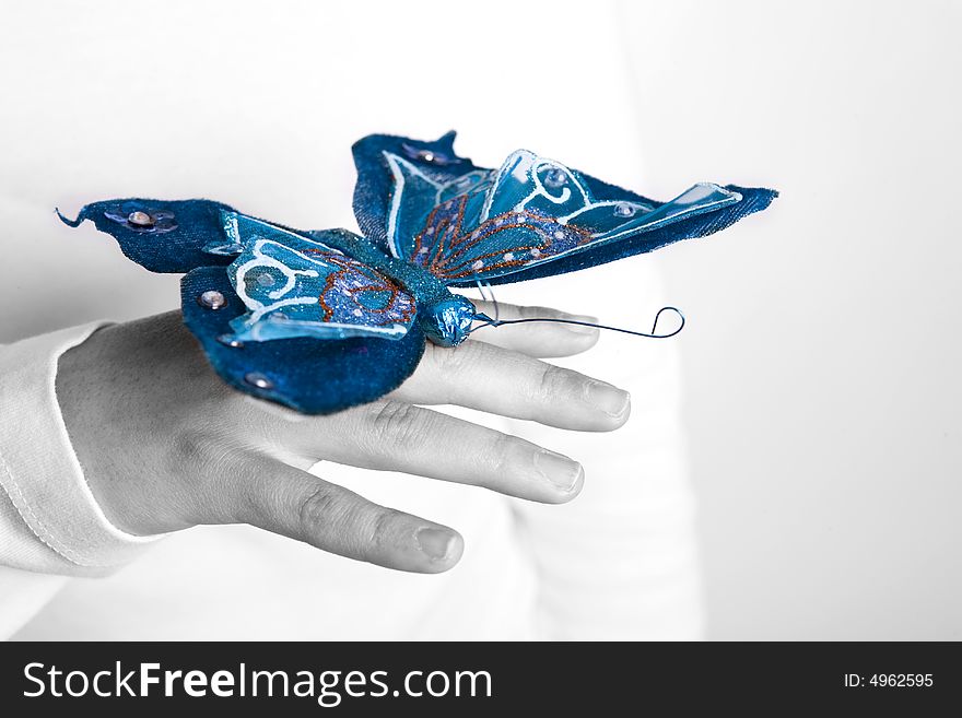 Blue butterfly in woman hand - selective color on the butterfly