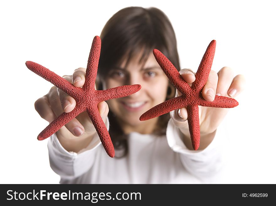 Young woman playing with red starfish seashell isolated on white background