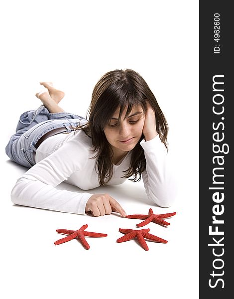 Young woman playing with red starfish seashell