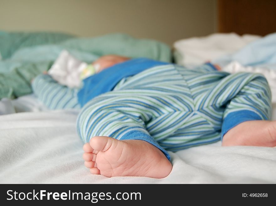 Feet of a little baby sound asleep at naptime. Feet of a little baby sound asleep at naptime