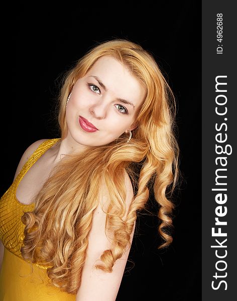 Pretty young girl in yellow dress on black background