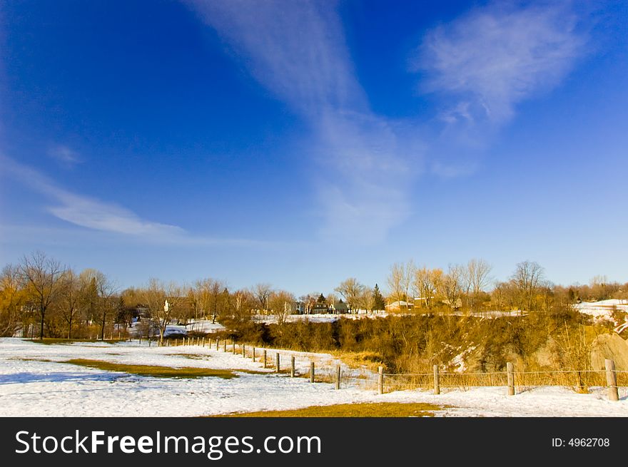 A landscape with some snow on the ground, blue sky in begining of spring. A landscape with some snow on the ground, blue sky in begining of spring