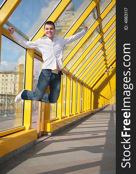 Young man jumps on footbridge