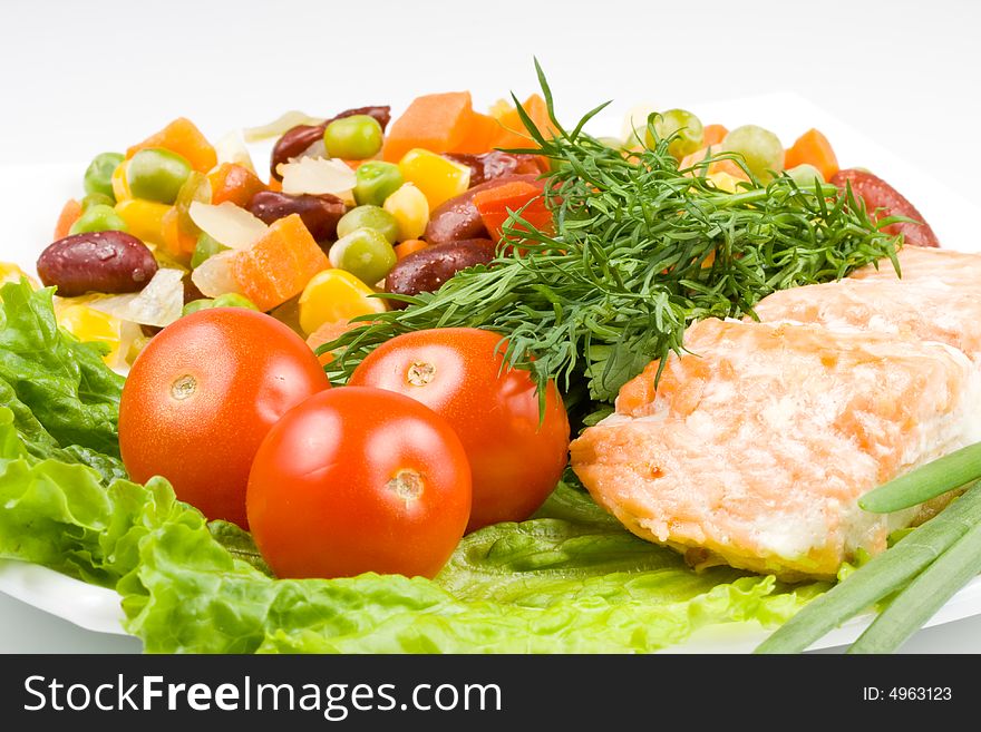 Stake from a salmon with vegetables on a plate