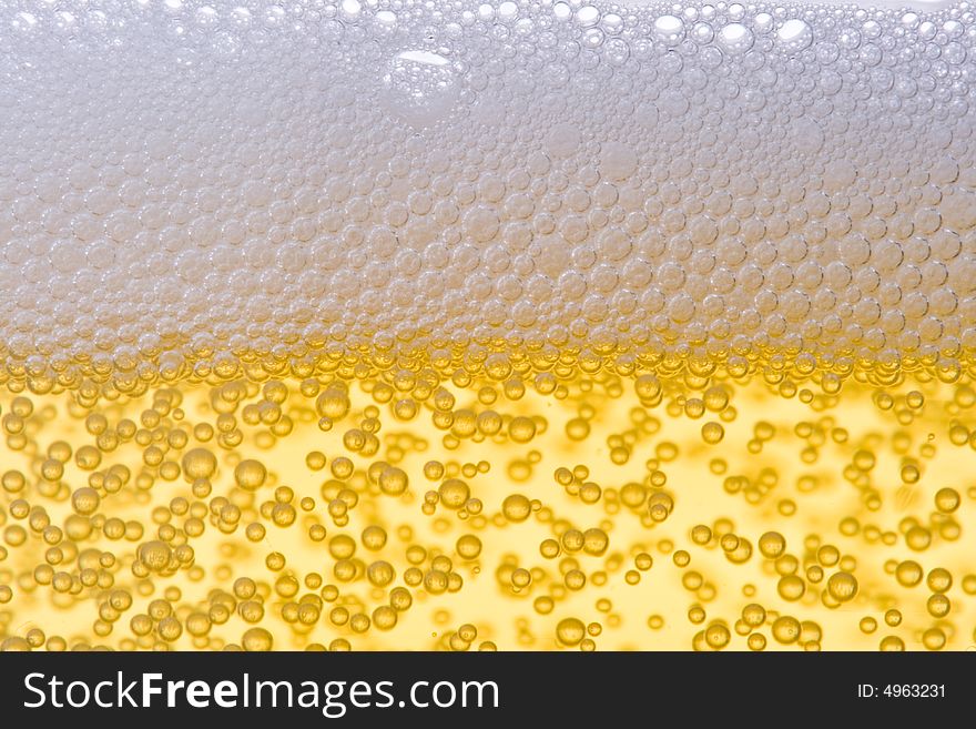 Background from fresh foamy beer with bubbles. Close-up. Background from fresh foamy beer with bubbles. Close-up.