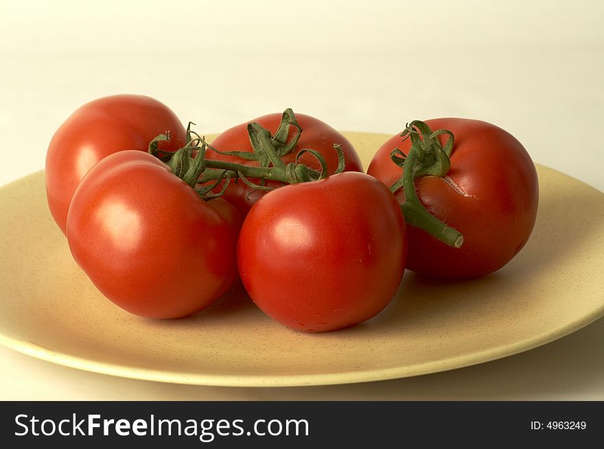Five tomatoes into a dish. Five tomatoes into a dish