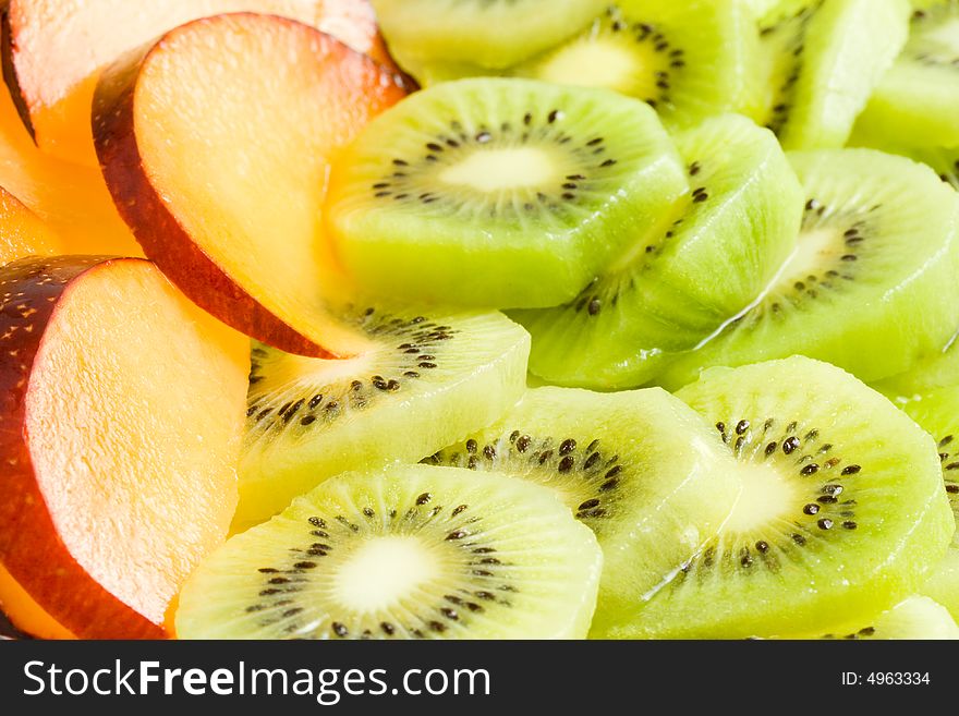 Background from sliced kiwi and plums. Background from sliced kiwi and plums.