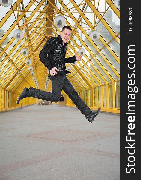 Guy jump and allegorize play on guitar on footbridge. Guy jump and allegorize play on guitar on footbridge