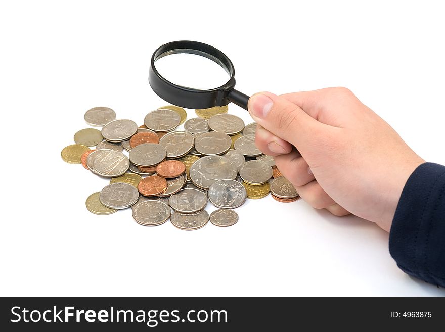 Coins and magnifier in hand on white