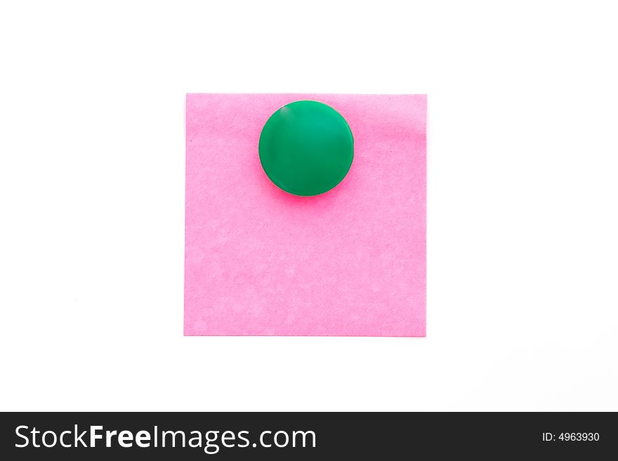 Red note with green magnet on white. Red note with green magnet on white