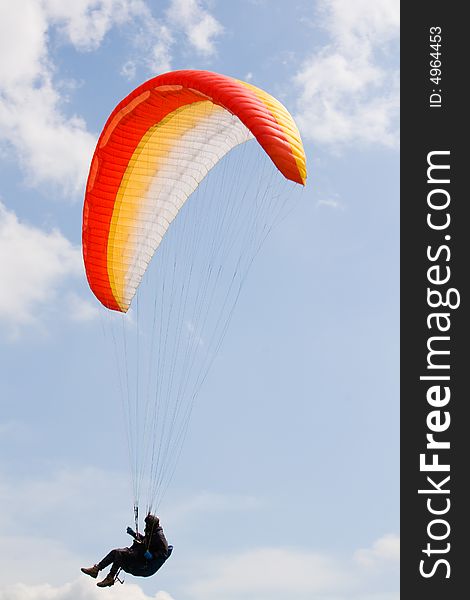 Paraglider in the blue cloudy skies. Paraglider in the blue cloudy skies