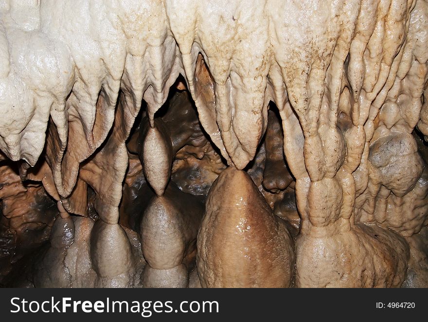 Wet rocks inside of a cave showing years of developement. Wet rocks inside of a cave showing years of developement.