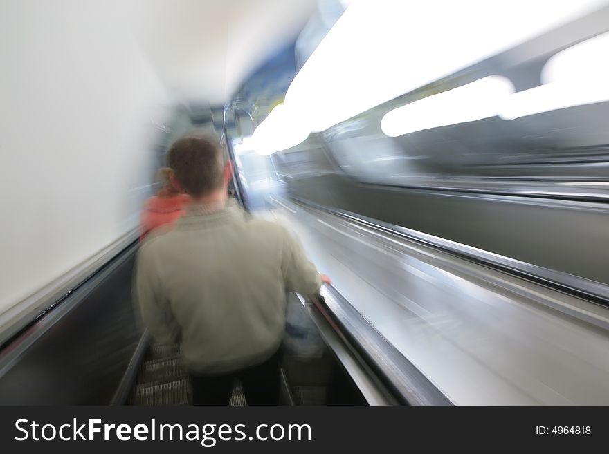 Abstract escalator with passengers. blur motion
