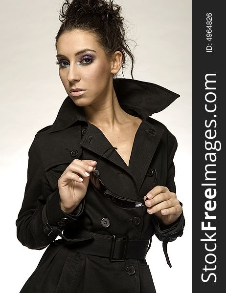 Portrait of beautiful brunette girl with sunglesses and black coat. Portrait of beautiful brunette girl with sunglesses and black coat