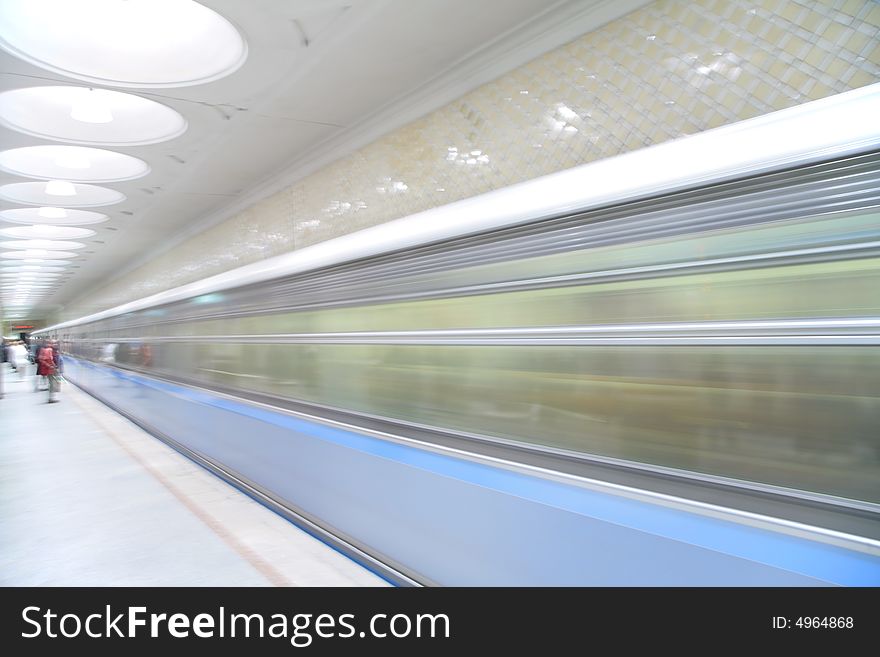 Passengers and moving train on metro station