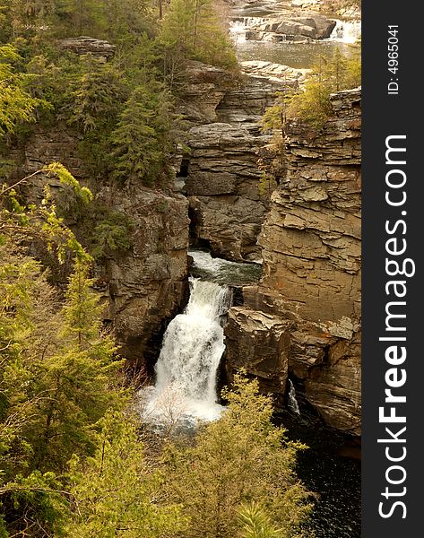 A waterfall on a cliff-side in rural North Carolina in Pisgah''s national forest. A waterfall on a cliff-side in rural North Carolina in Pisgah''s national forest.