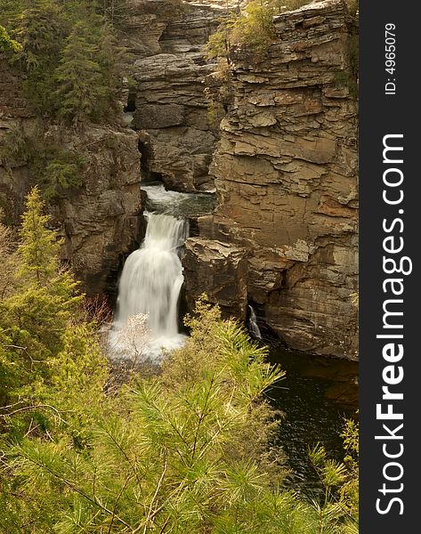 A waterfall on a cliff-side in rural North Carolina in Pisgah''s national forest. A waterfall on a cliff-side in rural North Carolina in Pisgah''s national forest.