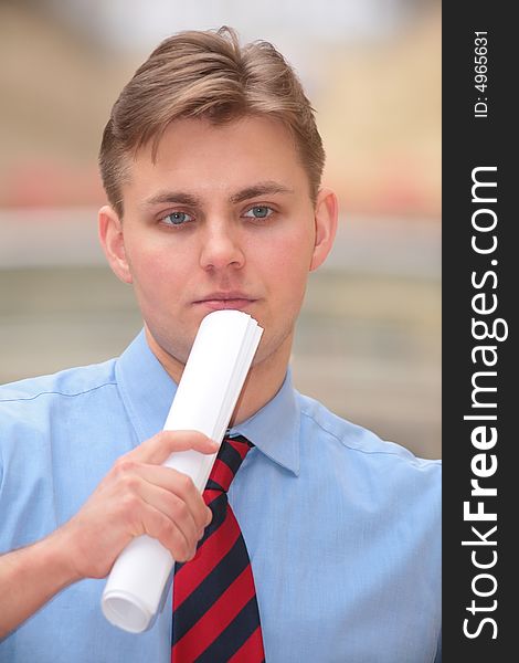 Young Businessman With Folded Papers